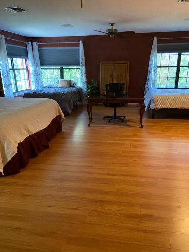 a bedroom with two beds and a desk with a piano at Shared Awesome Villa in Melbourne