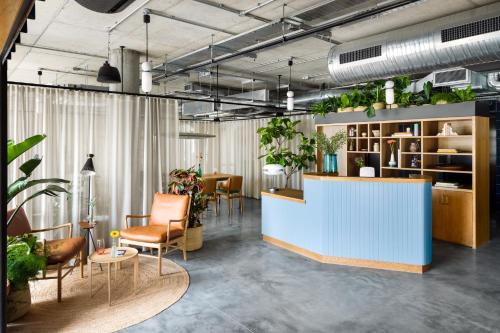 a lobby with plants on the walls and a counter at Turing Locke Cambridge in Cambridge