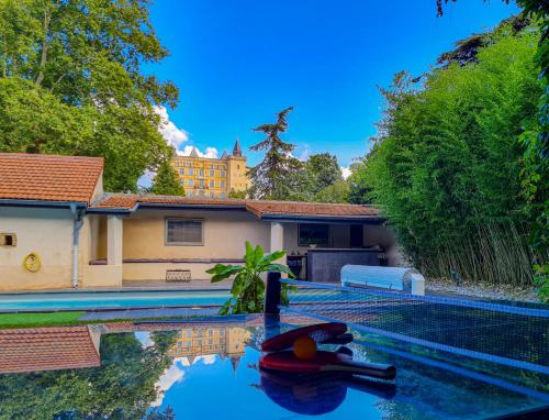 a villa with a swimming pool and a house at Lyon Faubourg - Saint Priest in Saint-Priest