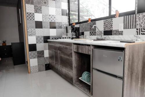 a kitchen with a sink and a counter top at Casa Vainilla 3 in Oaxaca City