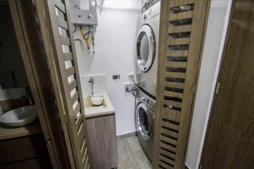 a bathroom with a washing machine and a sink at Hermoso y Amplio Apartamento Frente al Mar. in Cartagena de Indias