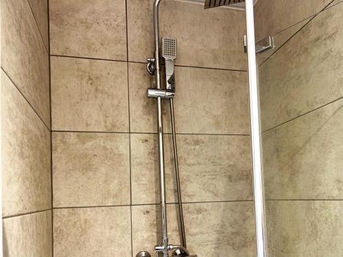 a shower with a shower head in a bathroom at Minet Gardens - Modern Centrally located - Suite 5 in London