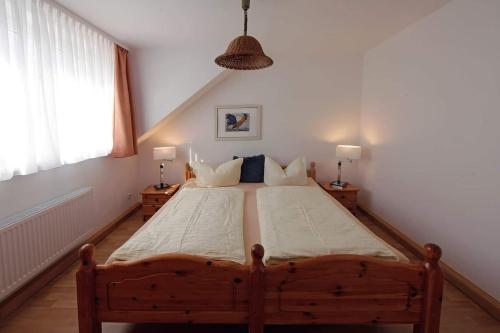 a bedroom with a large wooden bed in a room at Haus Müritz, 14 Roter Milan in Zielow