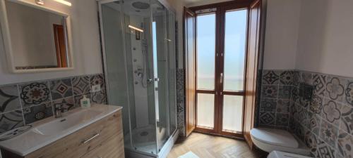 a bathroom with a shower and a sink and a toilet at Karales Antica Dimora in Cagliari