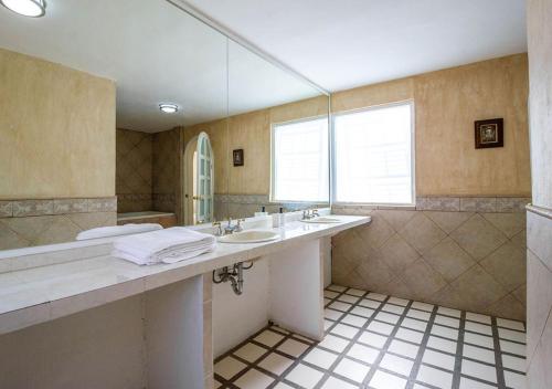 a bathroom with two sinks and a large mirror at Casa InHome, your home at Oaxaca in Oaxaca City