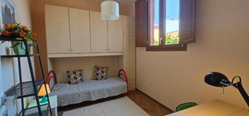 a small room with a bed and a window at Karales Antica Dimora in Cagliari