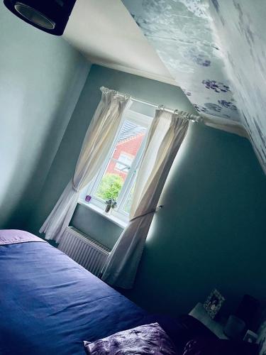 a bedroom with a bed and a window at The Grange in Admaston