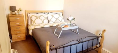 a bedroom with a bed with a table on it at Comfy 2 Bedroom Flat near Edinburgh City Center in Edinburgh
