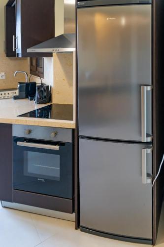 a stainless steel refrigerator in a kitchen at Theoxenia Kasos Luxury Apartments in Panayía