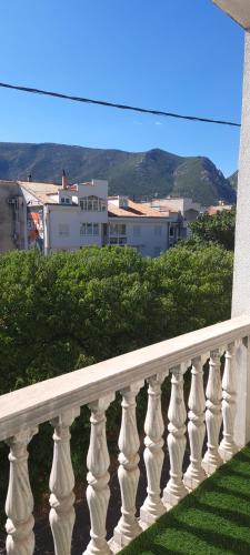 a white balcony with a view of a city at Gueshouse DaIris in Mostar