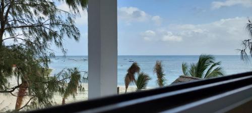 a view of the beach from a window at Aquarium Beach House in Nungwi