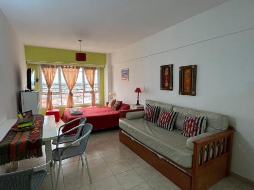 a living room with a couch and a table at DEPARTAMENTO PLAYA MIRAMAR in Miramar
