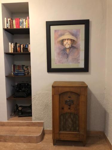 a painting of a man with a hat on a wall at Casona Gloria in Tarija