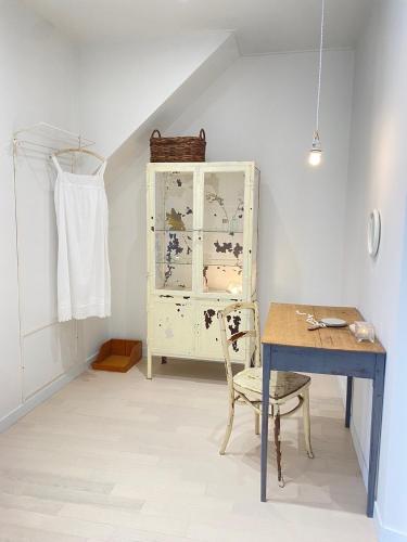 a dining room with a table and a cabinet at Maison de Clare in Gyeongju