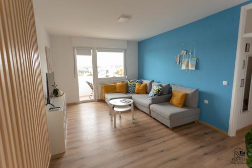 a living room with a couch and a table at Apartman Flumen in Vukovar