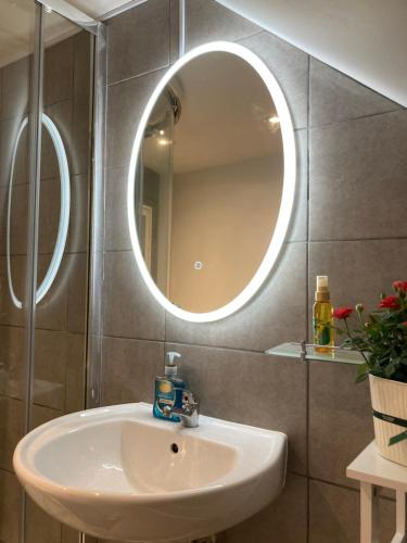 a bathroom with a sink and a mirror at 4 beds for 5 people beautiful apartment . in Plymouth