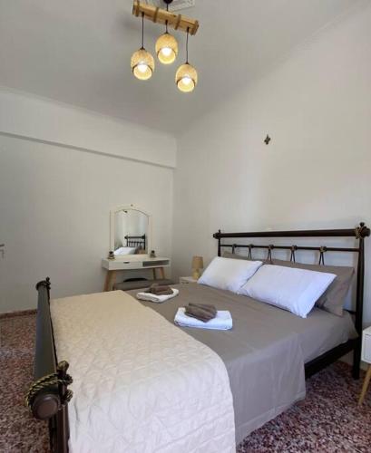 a bedroom with a bed and a table with a mirror at Cactus villa in Karpathos Town