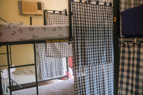 a room with two bunk beds and a window at La Terraza Hostel in Flores