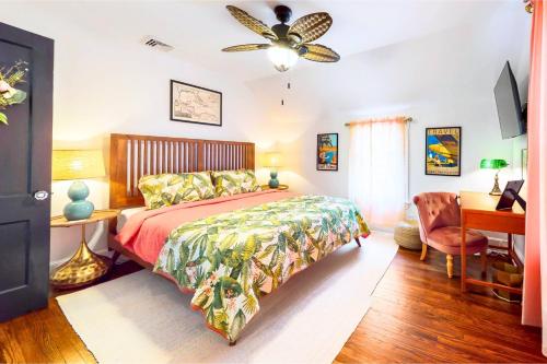 a bedroom with a bed and a desk and a ceiling fan at The Jewel of The Cove in New Haven