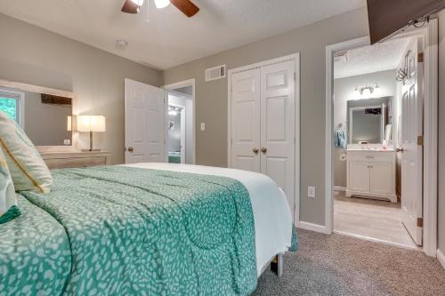 a bedroom with a bed with a green comforter at Charming Ohio Retreat with Deck, Porch and Gas Grill! in Howard