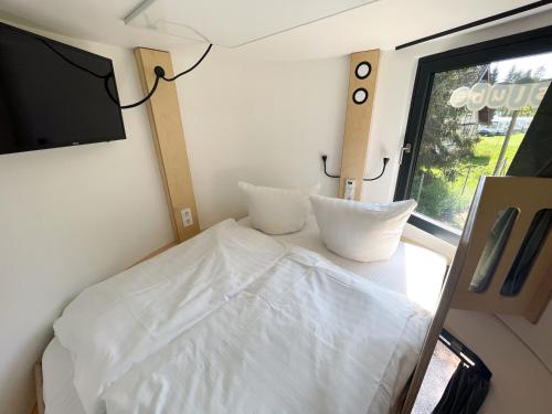 Kleines Zimmer mit einem Bett und einem TV in der Unterkunft slube am Krakower See in Krakow am See