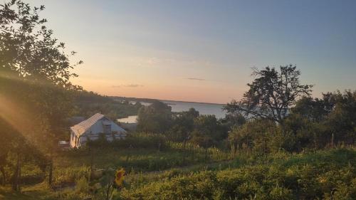 a house on a hill with a view of the water at Під рідним небом in Balyko-Shchuchinka