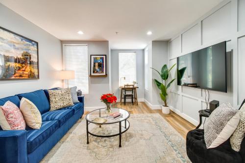 a living room with a blue couch and a table at Charming Alexandria Vacation Rental in Old Town! in Alexandria