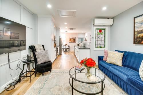 a living room with a blue couch and a table at Charming Alexandria Vacation Rental in Old Town! in Alexandria