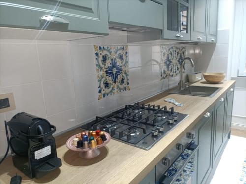 a kitchen with a stove and a bowl of pens at La luna piena in centro in Pescara