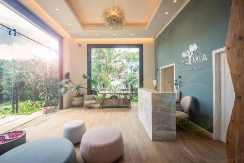 a lobby with a table and chairs and a large window at The Retreat Costa Rica - Wellness Resort & Spa in Atenas