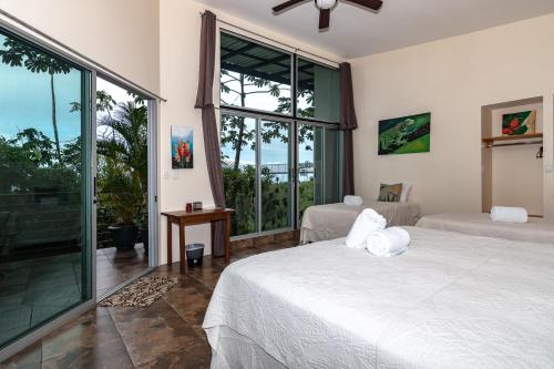 a bedroom with two beds and a large window at Hotel Finca 360 in Marsella