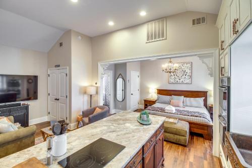 a large living room with a bed in the background at Cozy Savannah Vacation Rental with Fenced Courtyard! in Savannah