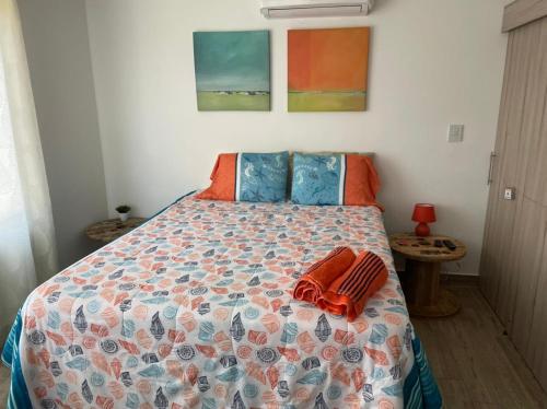a bedroom with a bed with a colorful comforter at PENTHOUSE EN MONTERRICO in El Sunzo