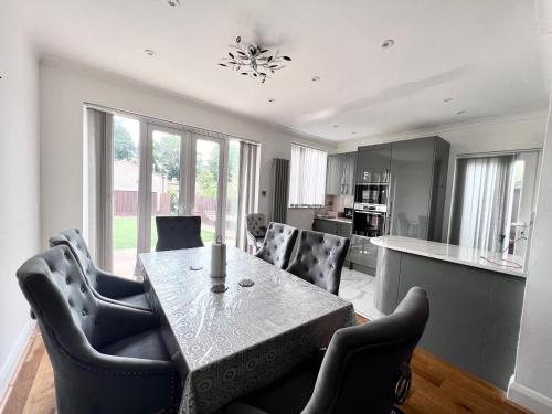 a dining room with a table and chairs in a kitchen at Family and Private Home in Norbury