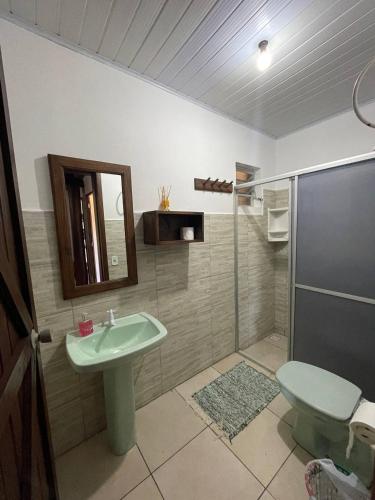 a bathroom with a sink and a shower with a toilet at Hostel e Camping Vale Mirante da Rocha in Timbe do Sul