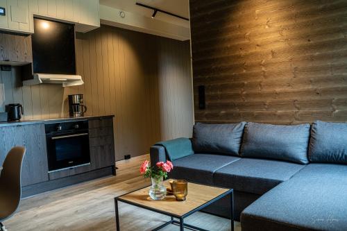 a living room with a couch and a table at Alpan Apartments, Lyngenfjord in Olderdalen