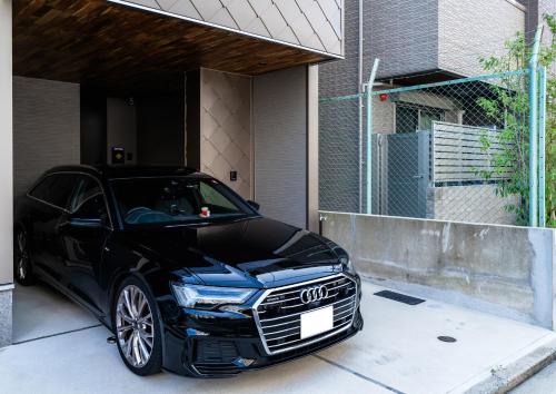 a black audi car parked in a driveway at Flower Base Fuji in Muromimachi