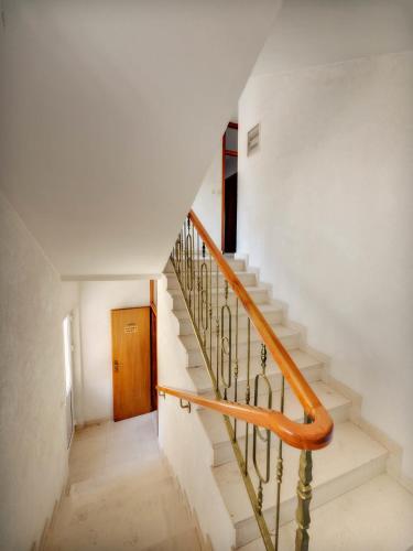 a staircase in a house with a wooden door at Villa Adria in Vodice