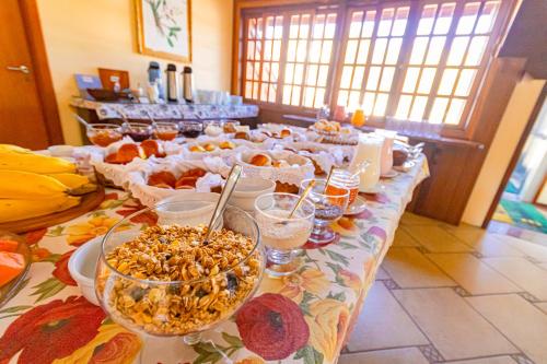 a table with a buffet of food on it at Pousada Alemã in Santo Antônio do Pinhal