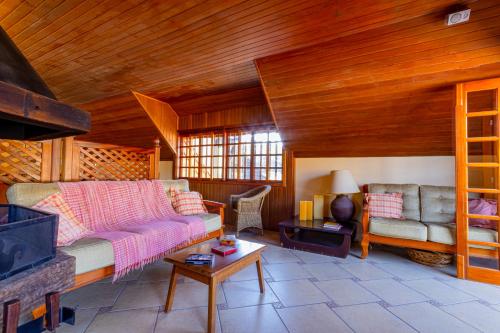 a living room with a couch and a fireplace at Pousada Alemã in Santo Antônio do Pinhal