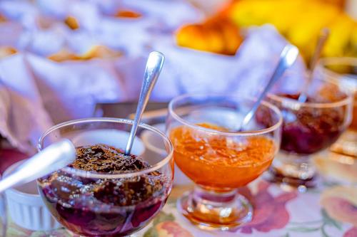 three glasses of food sitting on a table at Pousada Alemã in Santo Antônio do Pinhal