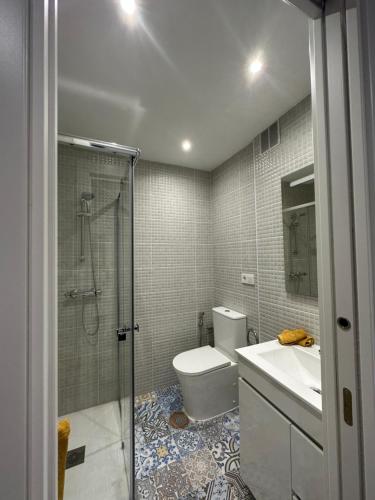 a bathroom with a shower and a toilet and a sink at Piso Sardinero - Almar d'Pipe in Santander