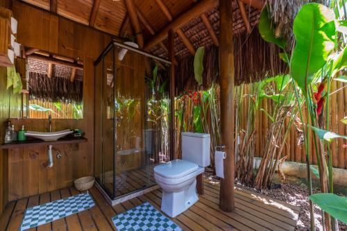 a bathroom with a toilet on a wooden deck at Sup House Barra Grande in Barra Grande
