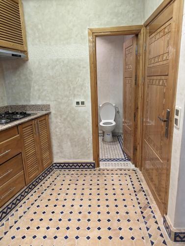 an empty bathroom with a toilet and a door at Mirleft View in Mirleft