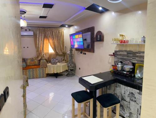 a living room with a table and chairs in a room at Modern Moroccan apartment near the beach in Safi in Safi