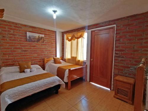 Postel nebo postele na pokoji v ubytování Lagoon Hotel Chugchilan