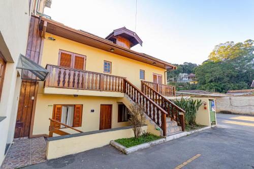 a house with a staircase on the side of it at Pousada Alemã in Santo Antônio do Pinhal