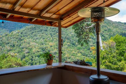 a lamp on a porch with a view of the mountains at Casa#7 in San José