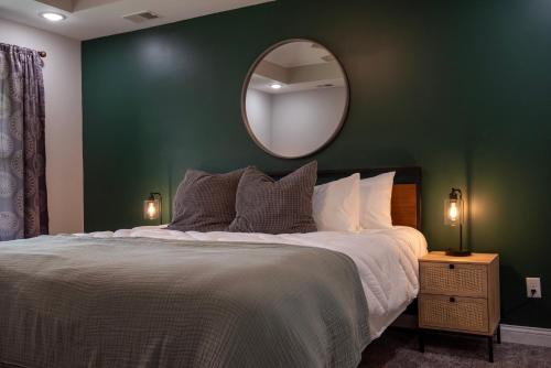 a bedroom with a large bed and a mirror at Bluegrass & Bourbon - a Peaceful Retreat & Hangout in Bardstown