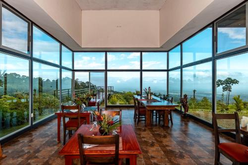 a large room with tables and chairs and large windows at Hotel Finca 360 in Marsella
